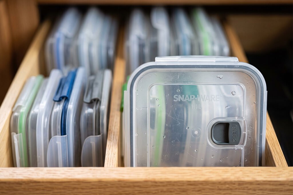A close-up view of container lids filed vertically front-to-back like index cards