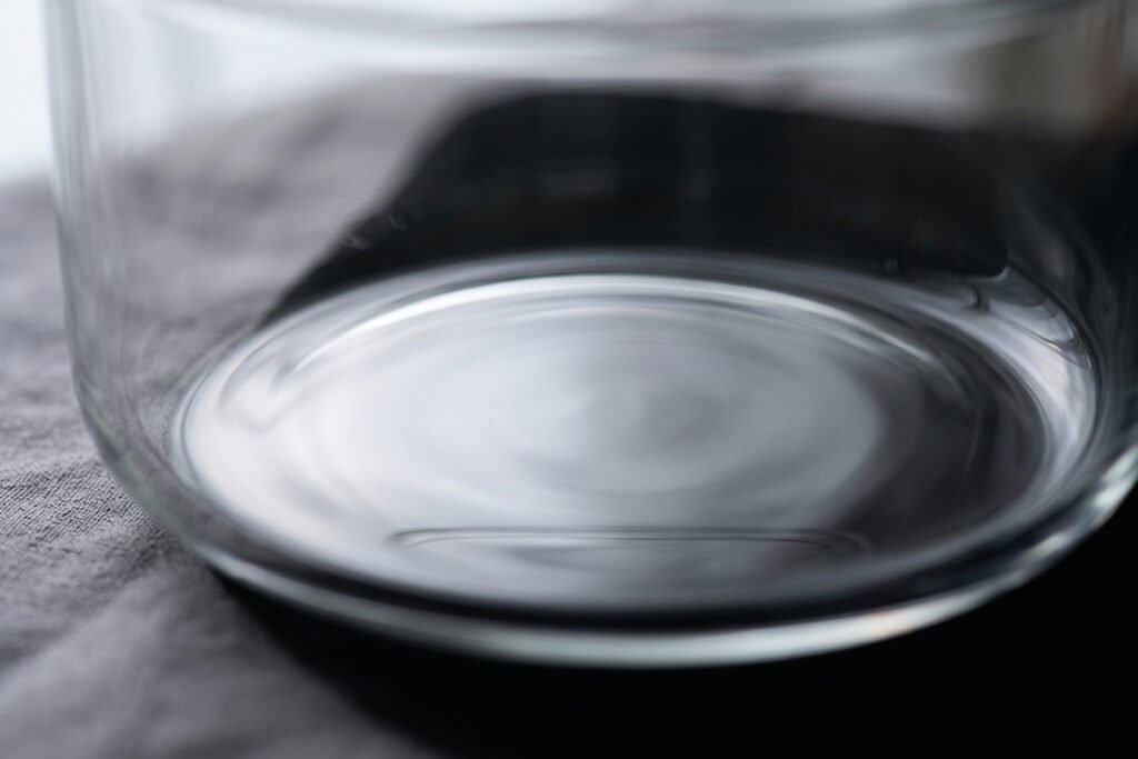 Close-up of a glass container base showing non-reactive