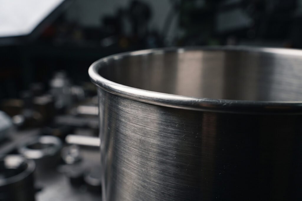 Close-up of a pure stainless steel container rim showcasing clean metal construction