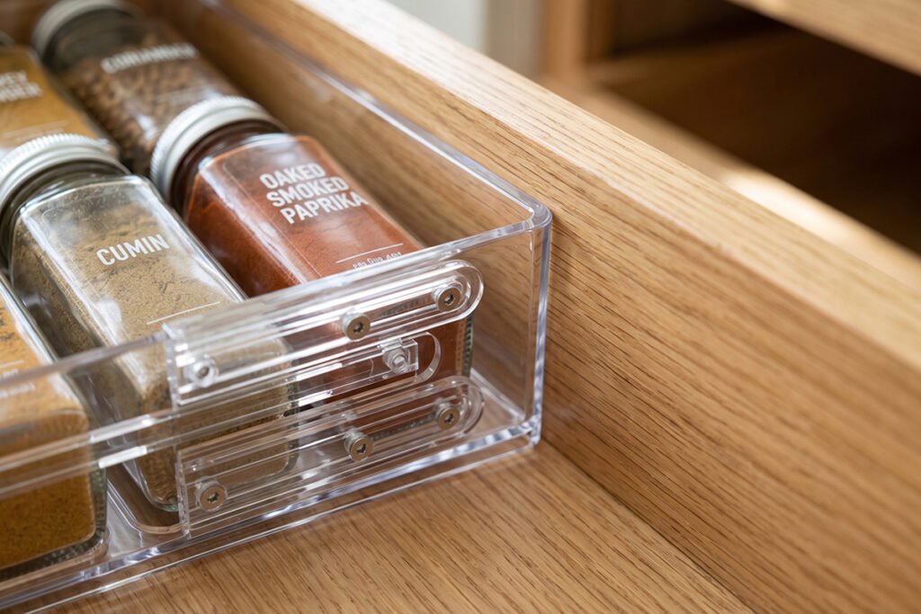 Close-up of an adjustable drawer spice tray expanded to fit perfectly against the i