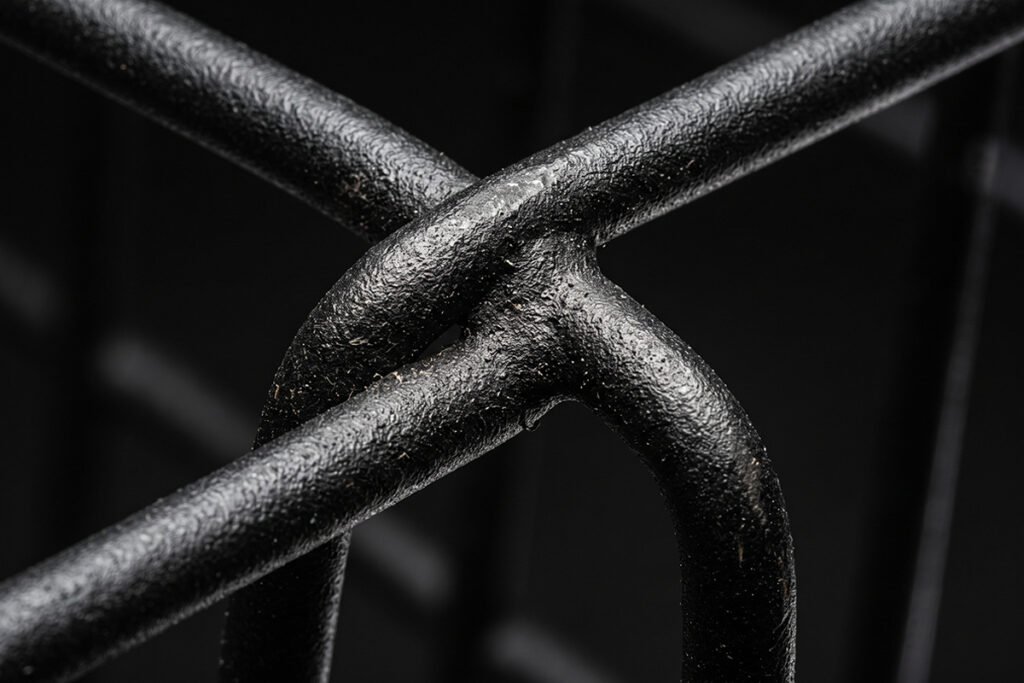 Close-up of the powder-coated matte black finish on a heavy-duty floor basket.