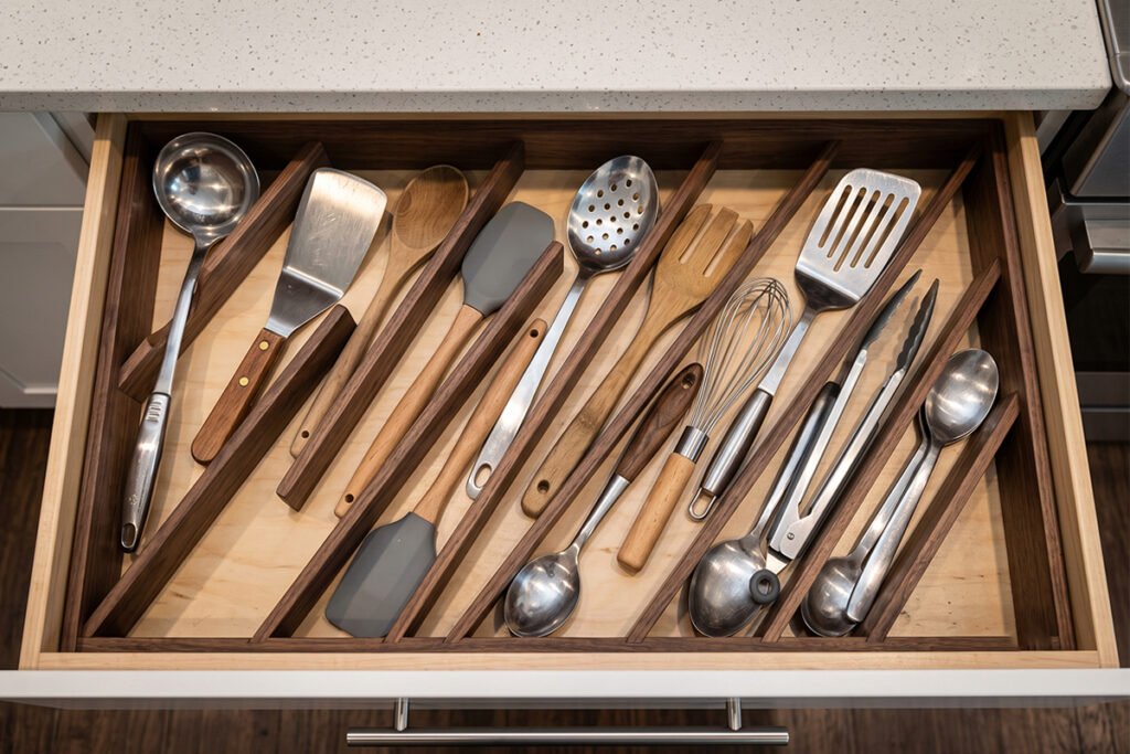 Extra-wide deep drawer organizer featuring diagonal slots filled with large cooking