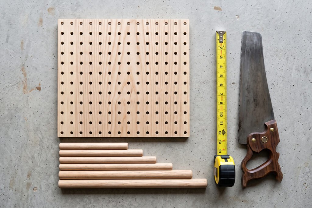Flat lay of DIY materials including a perforated pegboard